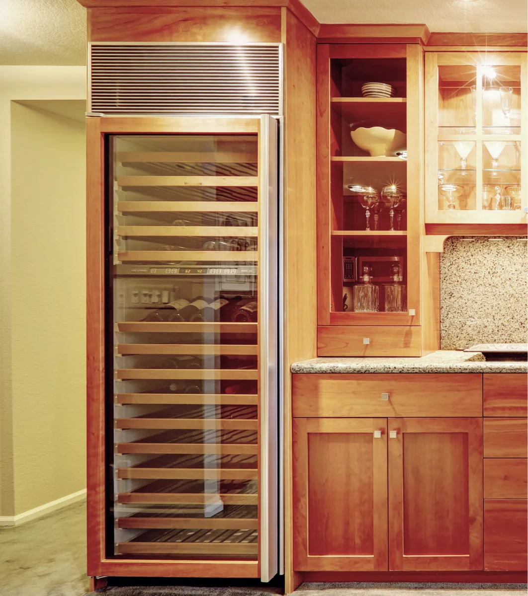 A kitchen with a wine cooler.
